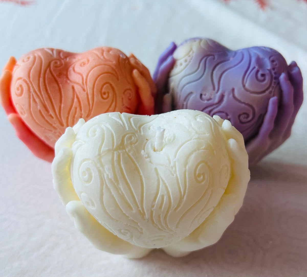 Handmade heart candles in white, pink and purple